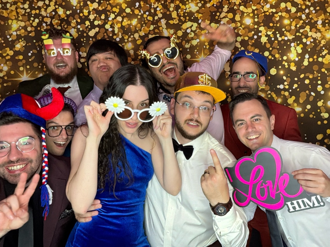 Group of wedding guests posing with props at a digital photo booth